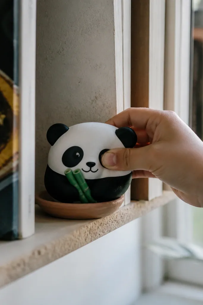 Small panda paper squishy with black patches and tiny bamboo stick accents