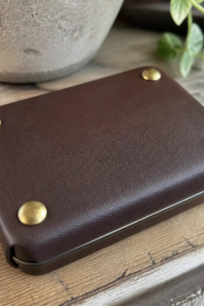 Brown faux leather Altoids wallet with four brass rivets at corners