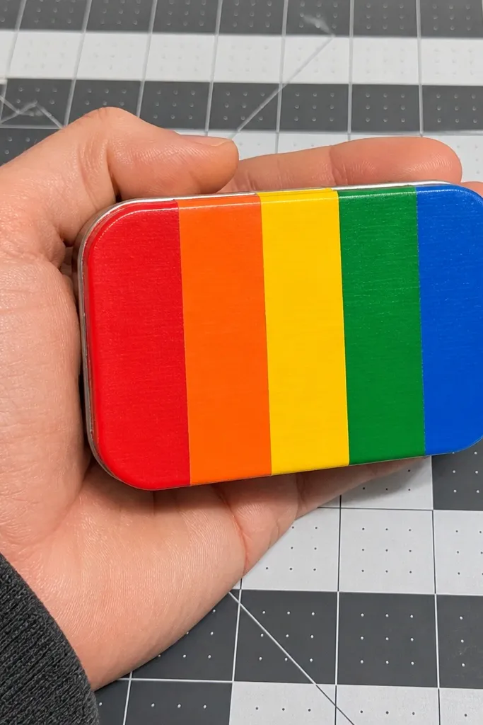 Altoids wallet wrapped in rainbow tape stripes with a clean centered magnet snap