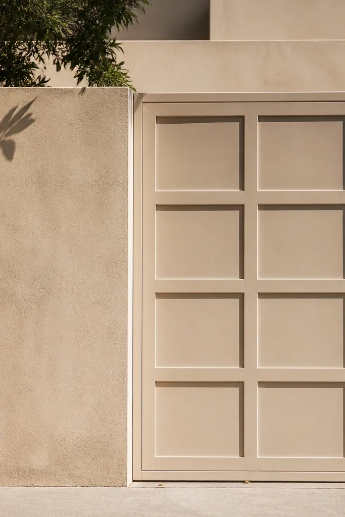 Beige wall with recessed rectangle panels on the gate