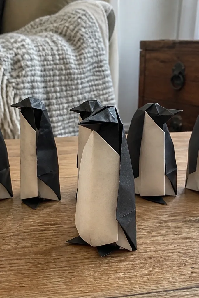 Folded penguin with a white belly and small beak crease