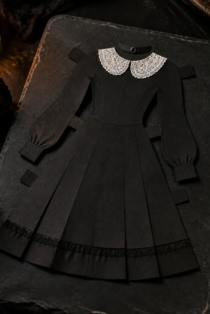 Paper doll in a black lace dress with a choker piece