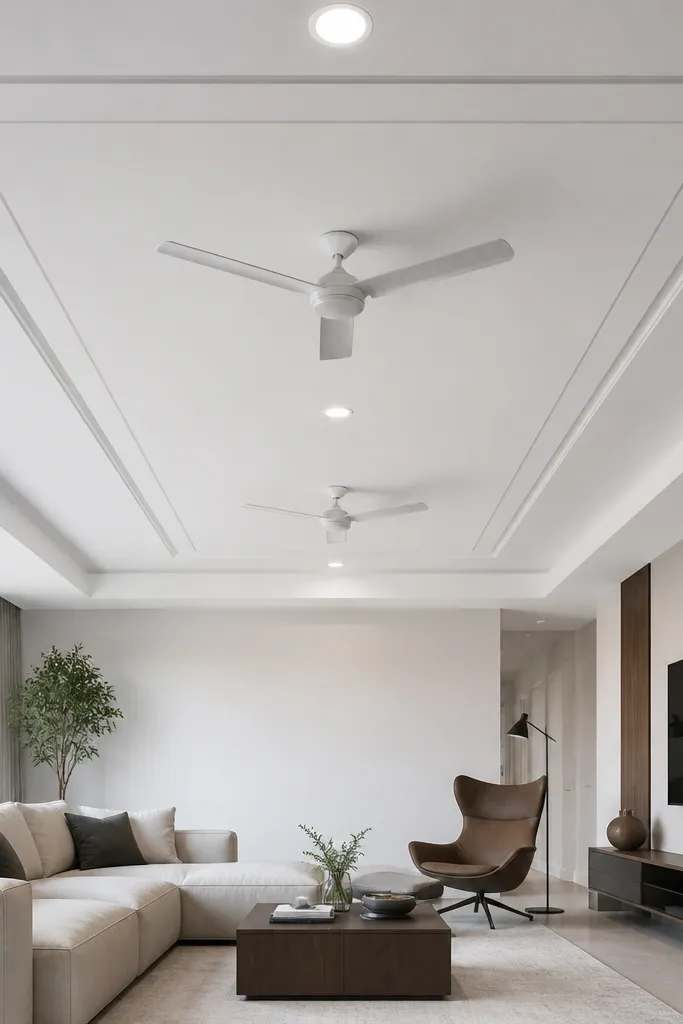 Two fans under a square double border, with downlights aligned along the center line.