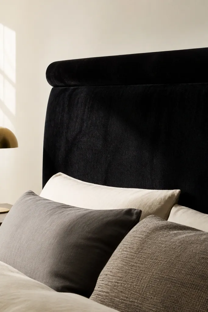 Black velvet headboard with a smooth rounded top edge