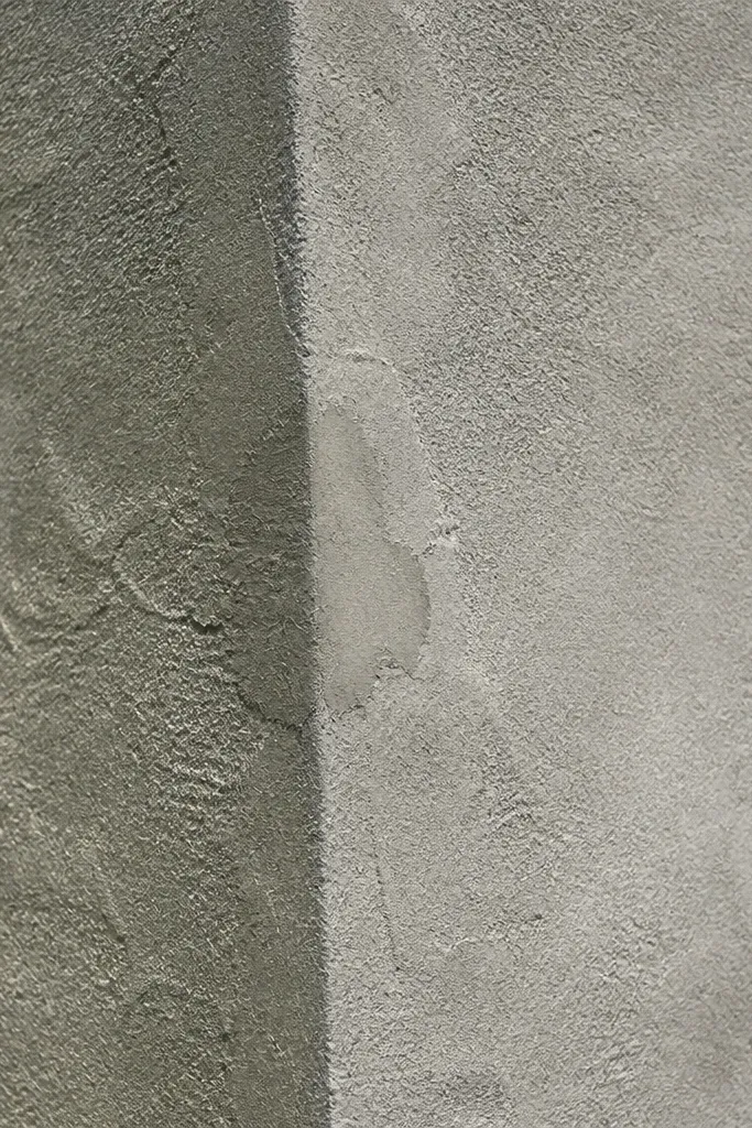Concrete wall with light textured plaster finish and straight vertical edges