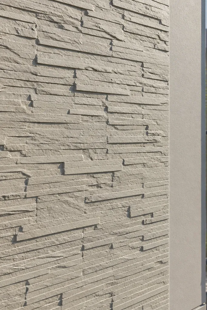Textured stone-slab style compound wall with light grey finish and dark joints