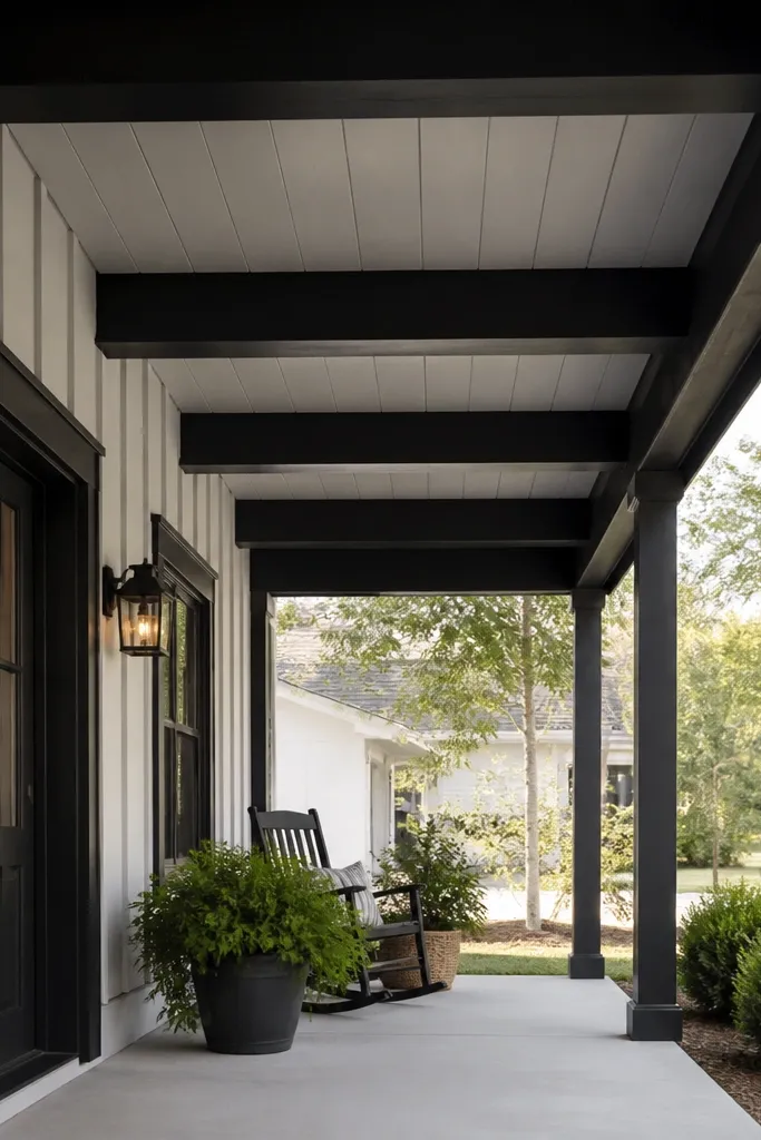 Porch ceiling with vertical board-and-batten lines and black beams under the entry