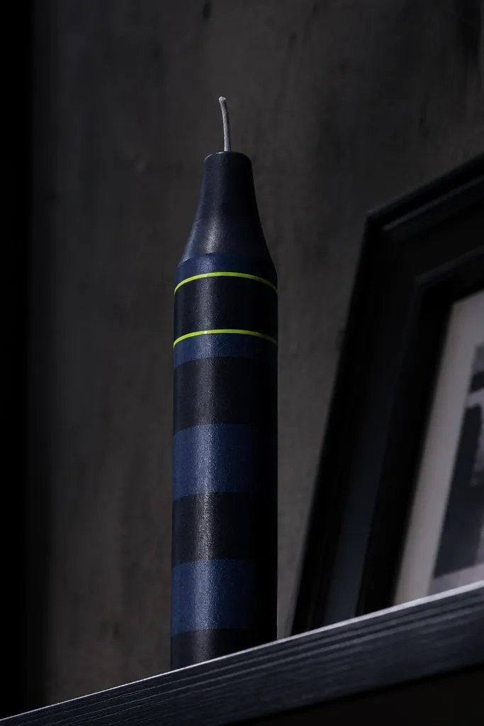 Candle with dark navy stripes and neon green outline
