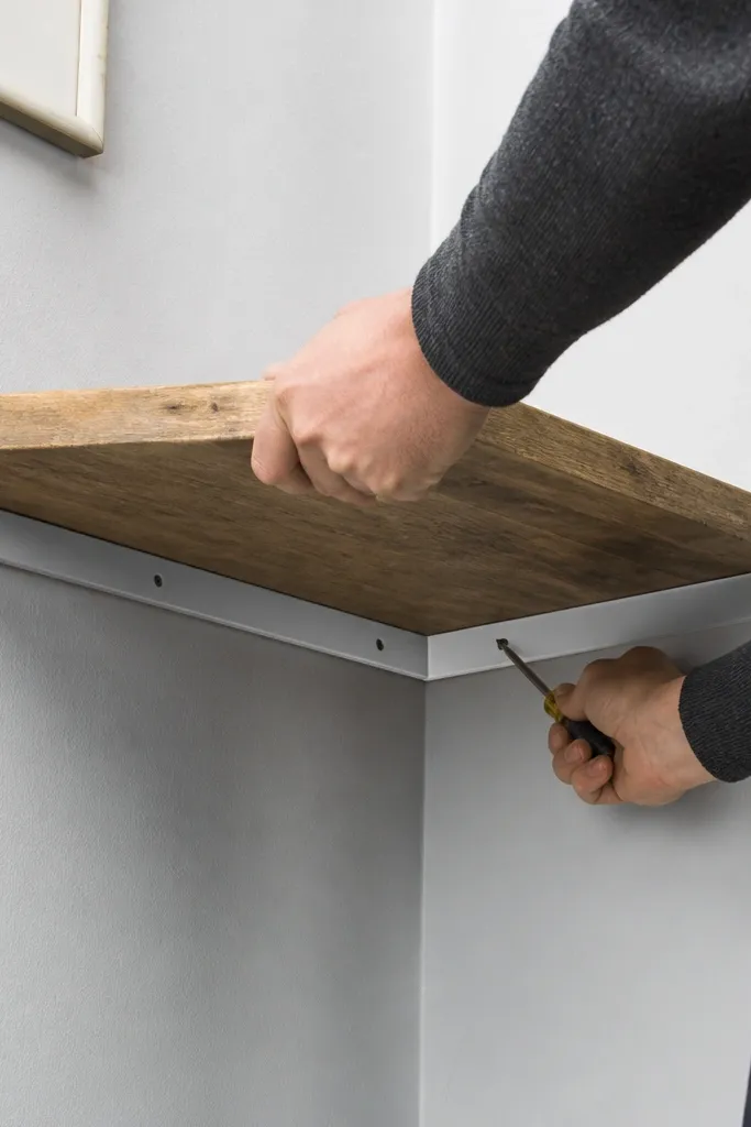 Corner shelf that is slightly tilted with a crooked mounting line
