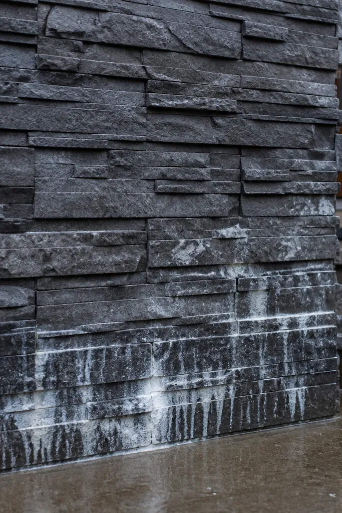 Stone veneer around a wall area with visible staining seams