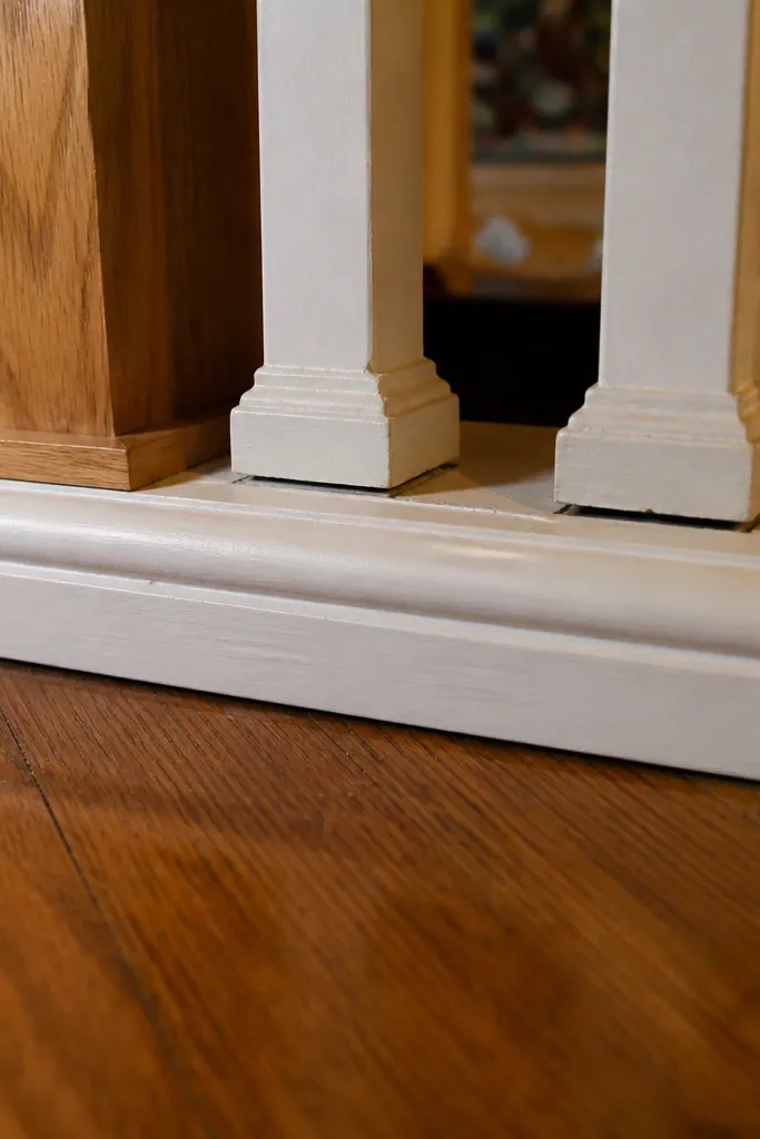 Bottom of stair railing with a base board and balusters attached