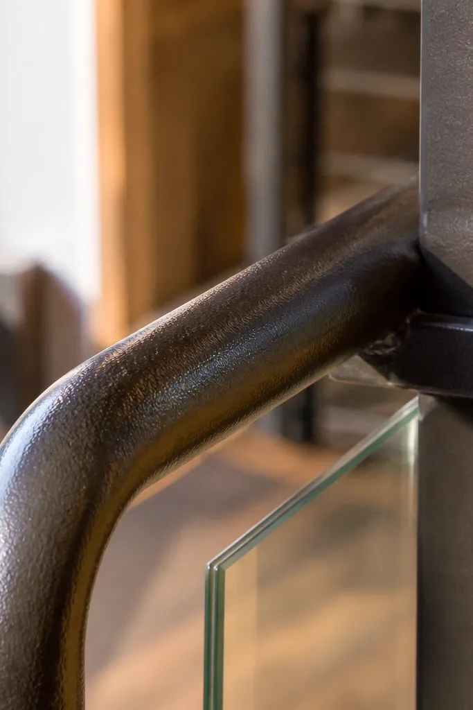Painted wood rail with tiny bumps and visible dust specks