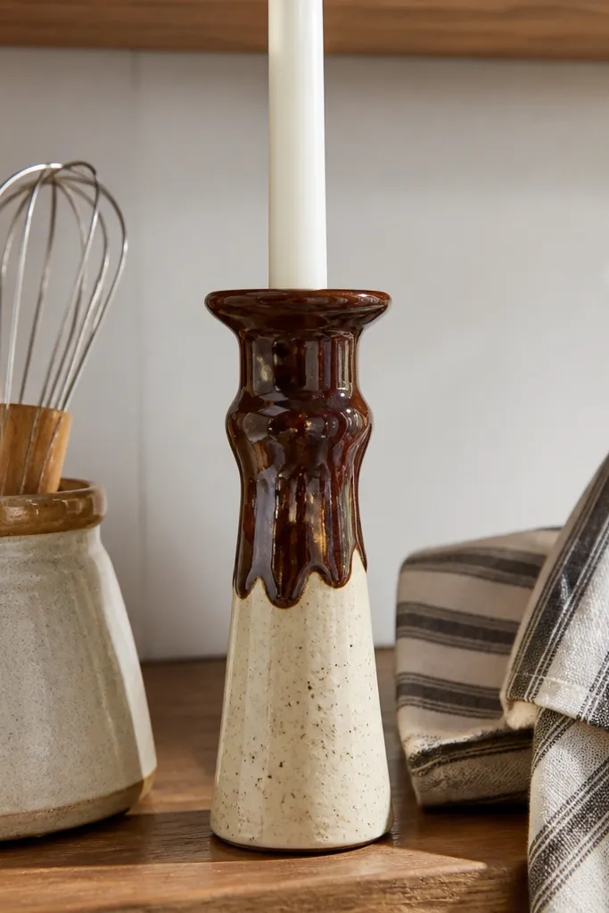 Cream candle with chocolate brown drip and scattered speckles