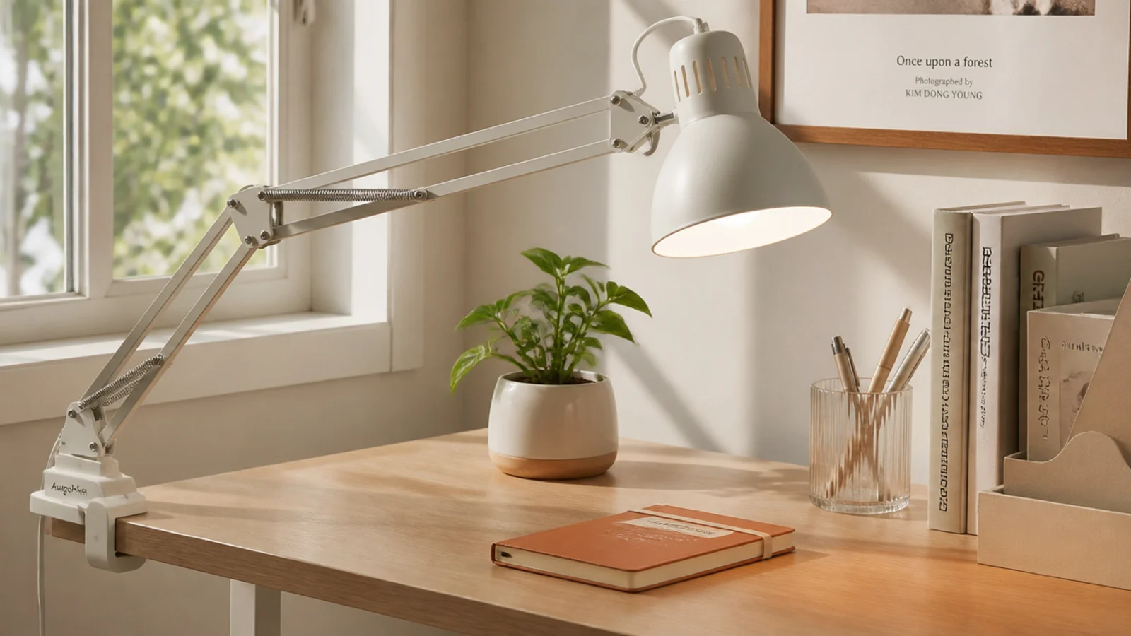 A clamp-on lamp attached to the edge of a dorm desk, its arm angled over the work area, using no surface space.