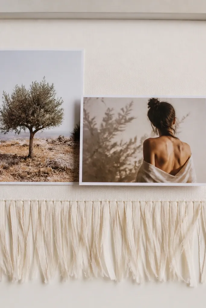 A cream frame with a fringe border made from thin fabric strips along the bottom edge. Photos sit above the fringe with a neutral color palette. A single thin gold chain line runs behind one photo.