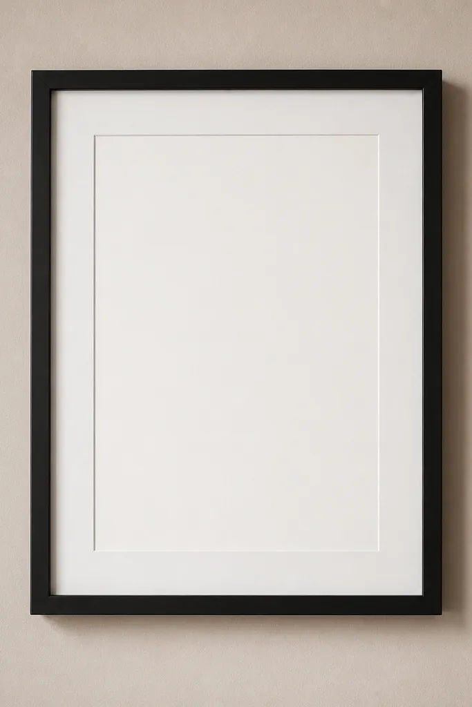 A minimal black foam-board instagram frame with a slim black inner border and a clean white matte window; photographed against a beige wall.