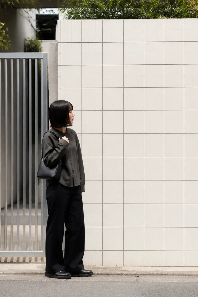 Matte white compound wall with evenly spaced tile grid panels
