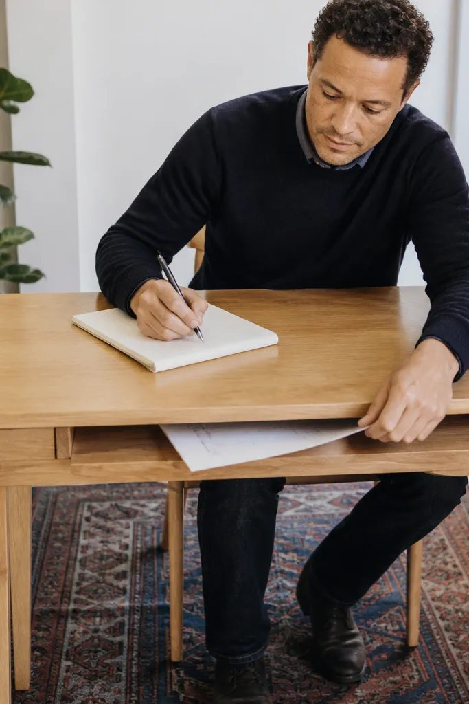 Desk with a concealed shelf for papers under the desktop