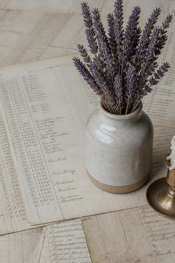 Muted ledger-page print laid under a centerpiece on a table