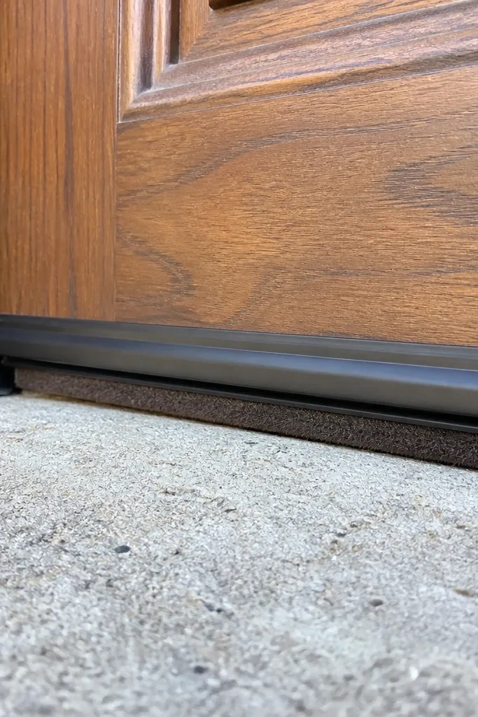 Door threshold with a clean metal track and weather seal strip