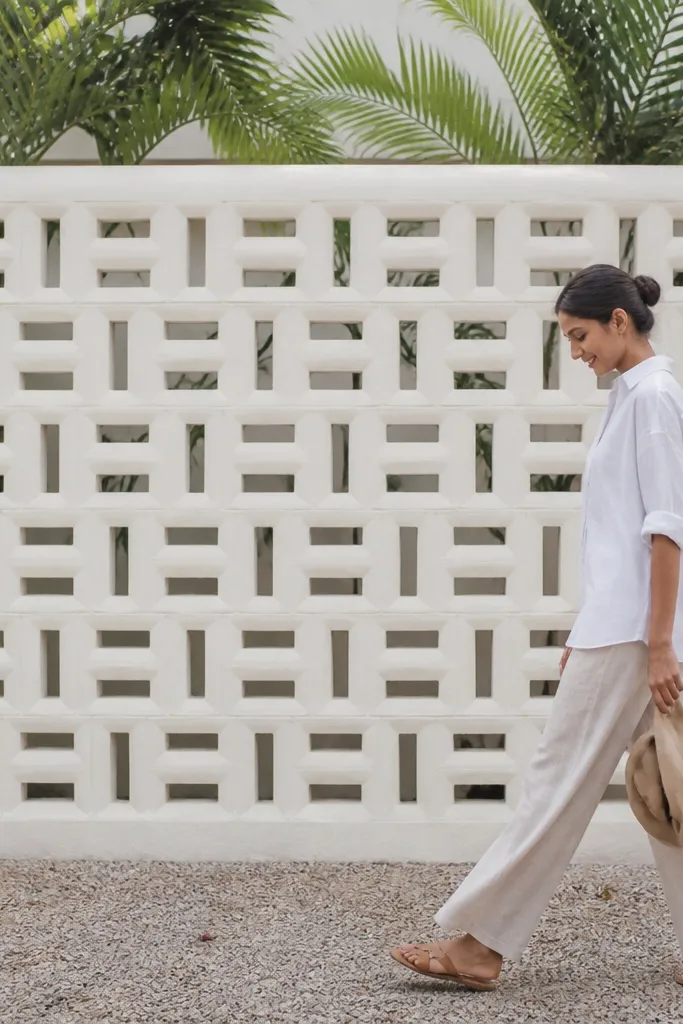 Light limewashed wall with alternating block pattern and a simple grey cap