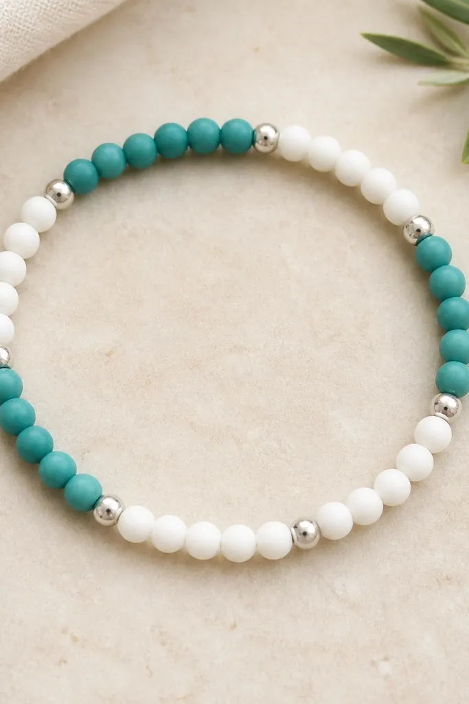 A bracelet shown flat: alternating blocks of teal and white clay beads, each block has 6mm beads separated by small 6mm silver spacer beads; the pattern repeats cleanly.