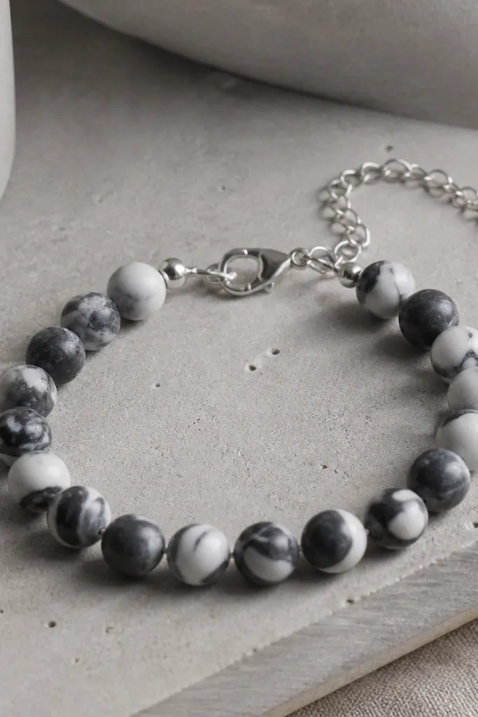 A marble black-and-white clay bead bracelet with 9mm beads; on the back is a silver chain extender so the fit adjusts by an inch.