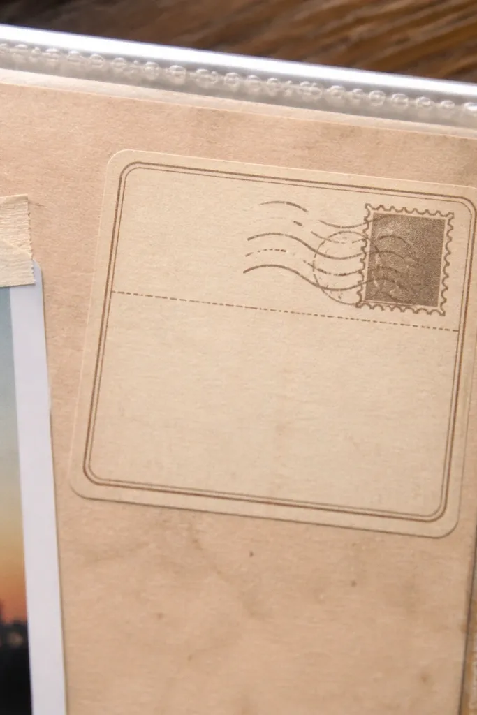 Small postcard corner label with faded stamp and a blank message box