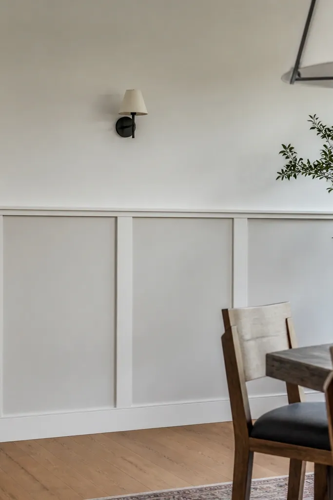Tall half-wall with vertical center posts and a chair rail