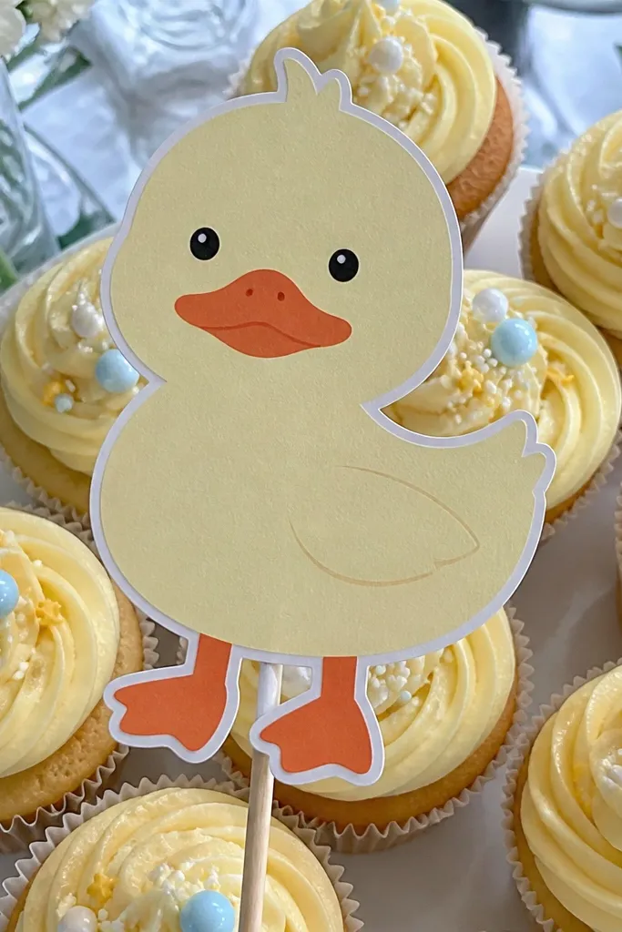 Duck face cutout on a wooden stick with yellow body and orange beak