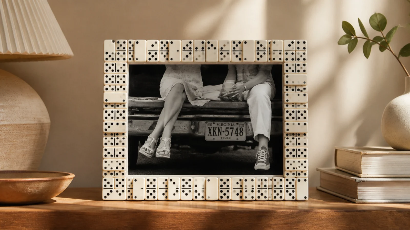 A frame border built from dominoes stood and glued end to end around a photo, graphic black and white.