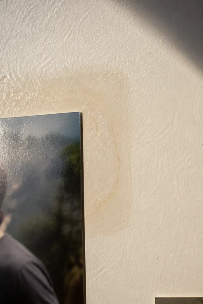 Clear tape residue on painted wall around a corner