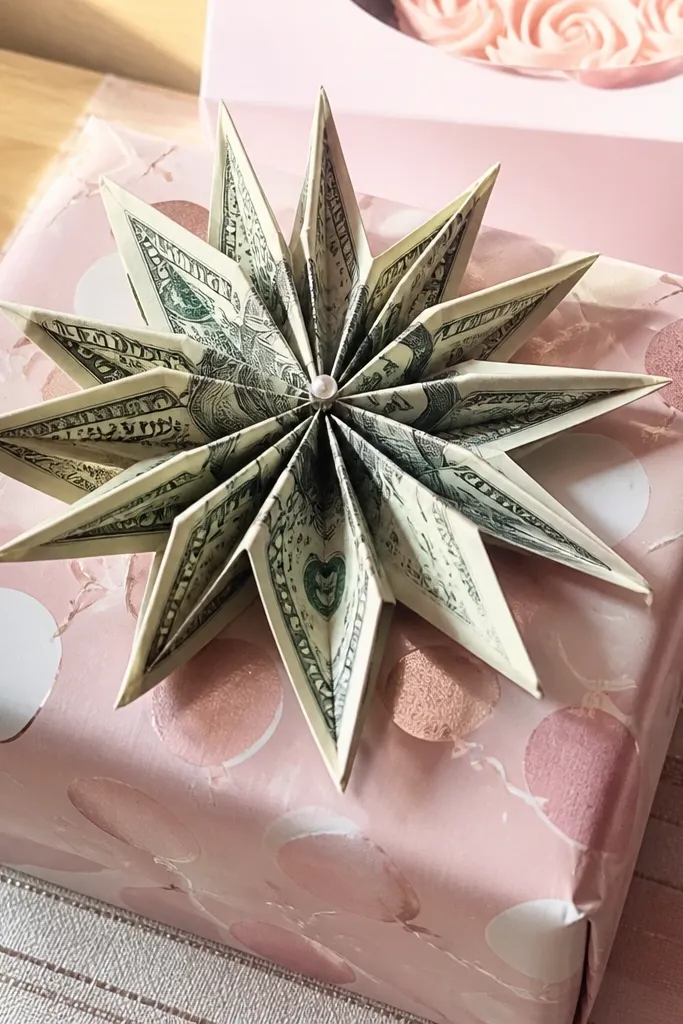 A $15 bill folded into a starburst with folded points radiating outward