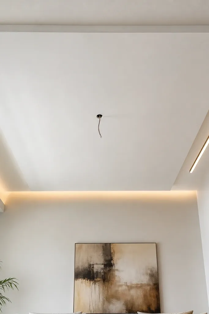 Flat white ceiling panel with straight perimeter line and hidden light wiring