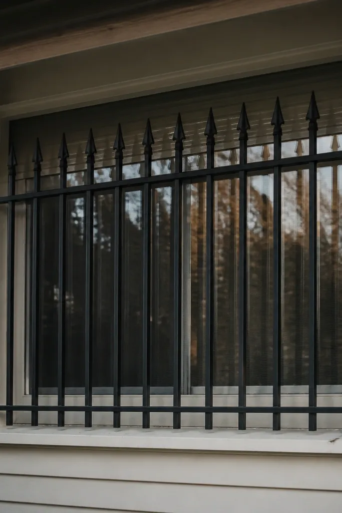 Window grill with spear-like pointed bars at regular intervals