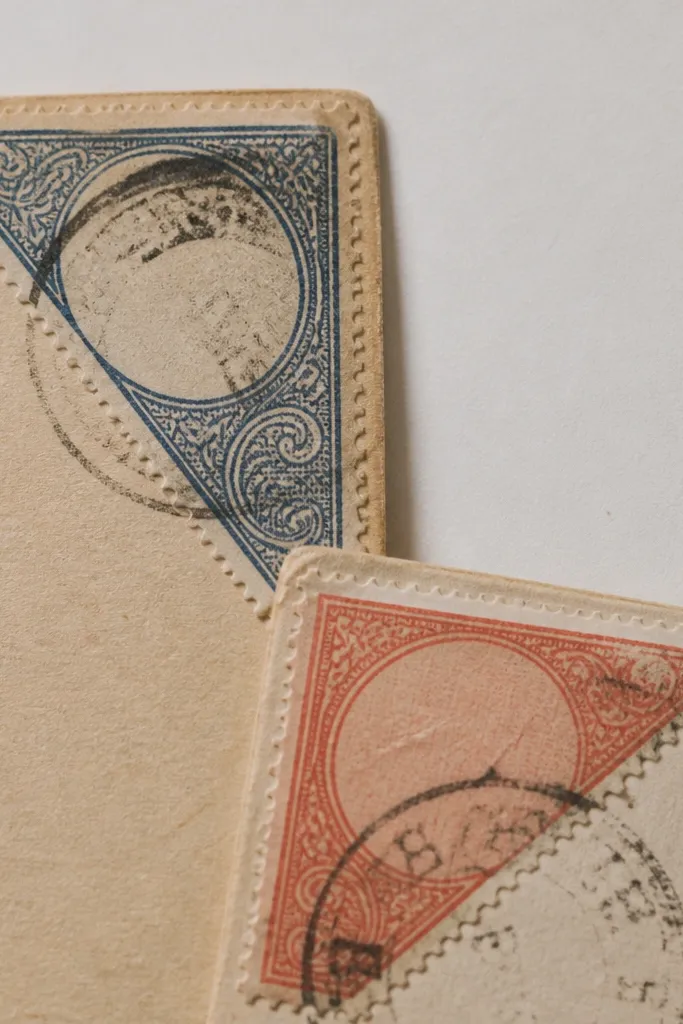 Postal corner stickers with faded stamps and perforated edges on paper