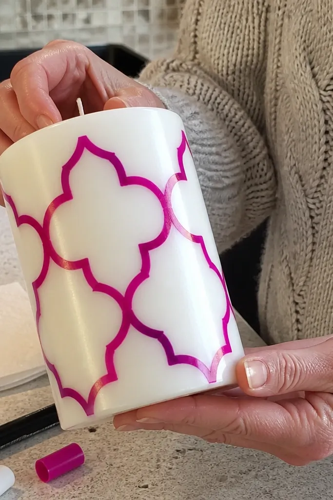 Tall candle with painted marker dots and a clean border line
