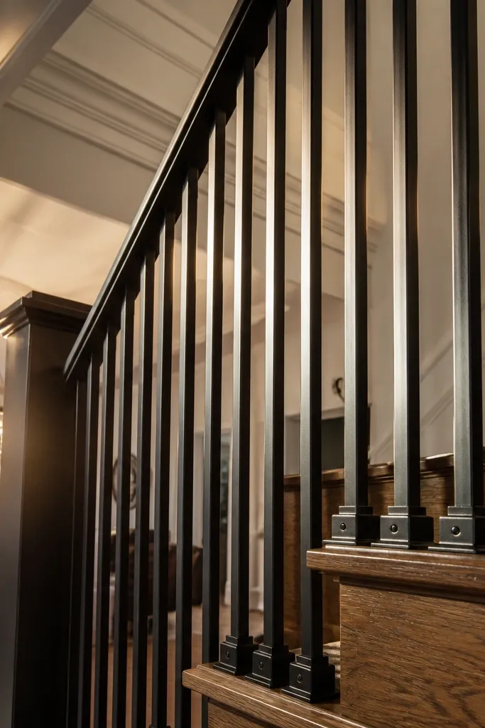 Matte black steel stair railing with vertical pickets and two sturdy end posts