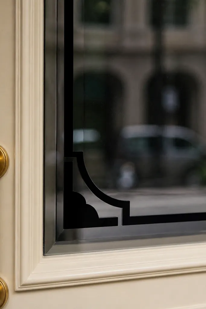 Matte corner decals on a front door window with a clean border