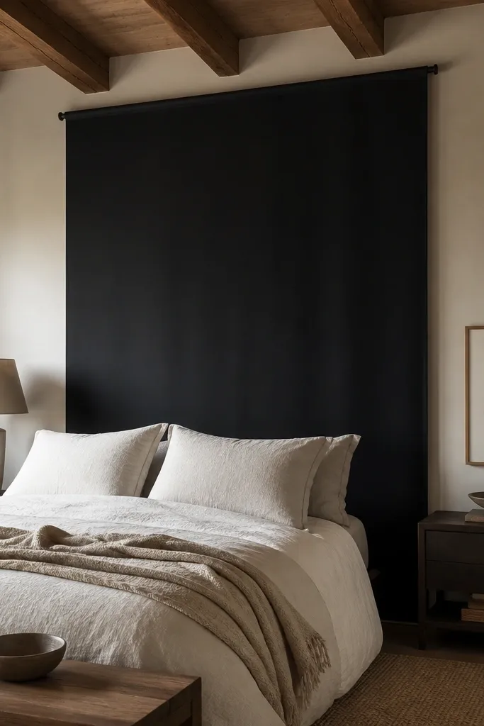 Blackout fabric panel on a ceiling track behind bed with sharp edges