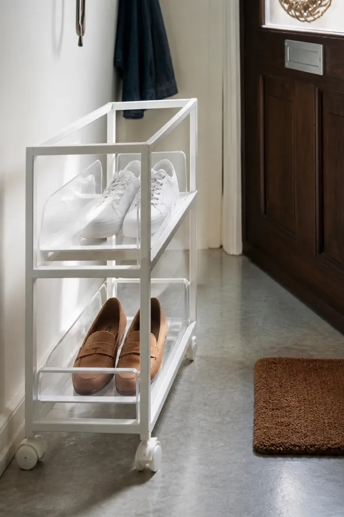 Narrow rolling cart with two shelves holding everyday sneakers and a small bin for laces