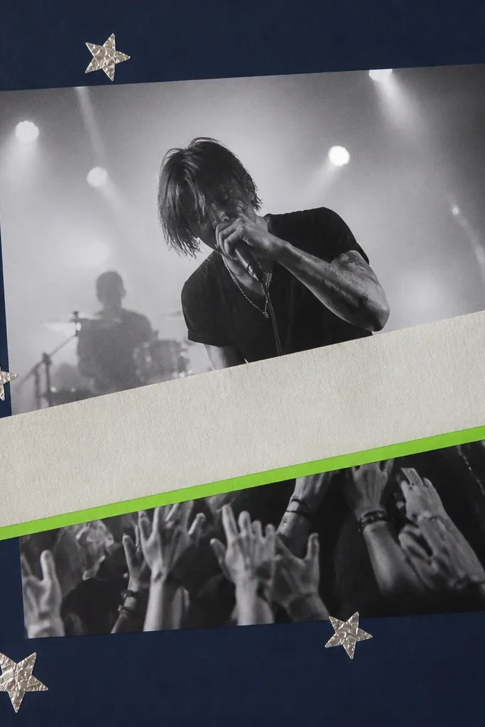 A dark navy page base. A band name ticket banner runs diagonally across the center. Small star shapes are made from silver foil tape scattered around a large concert photo. A thin strip of neon green cardstock underlines the title.