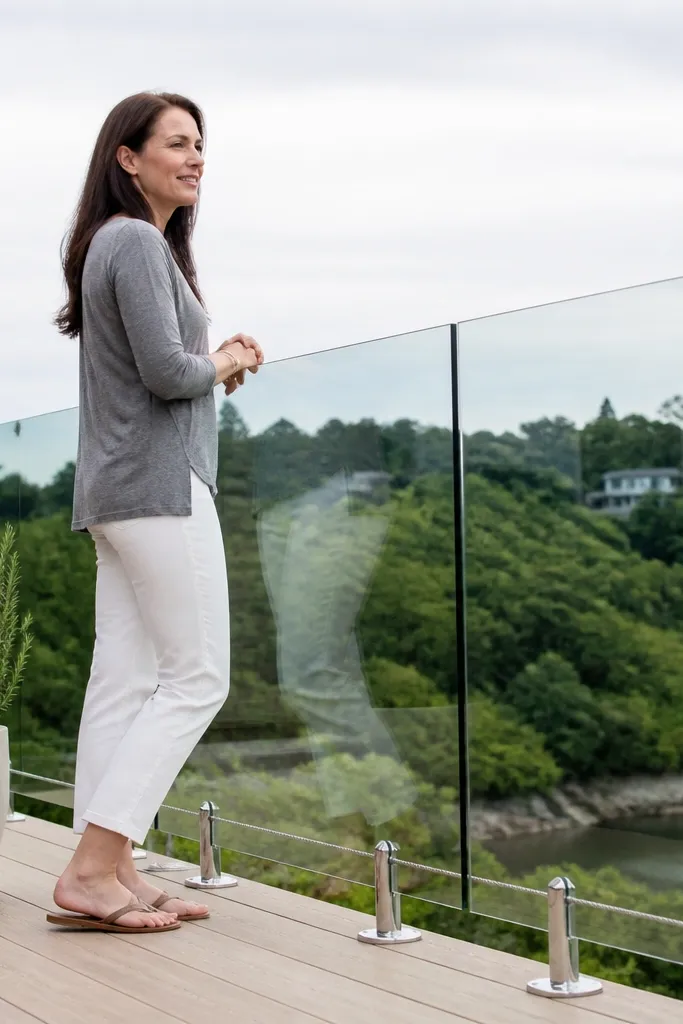 Clear glass panels with a stainless cable line near the bottom