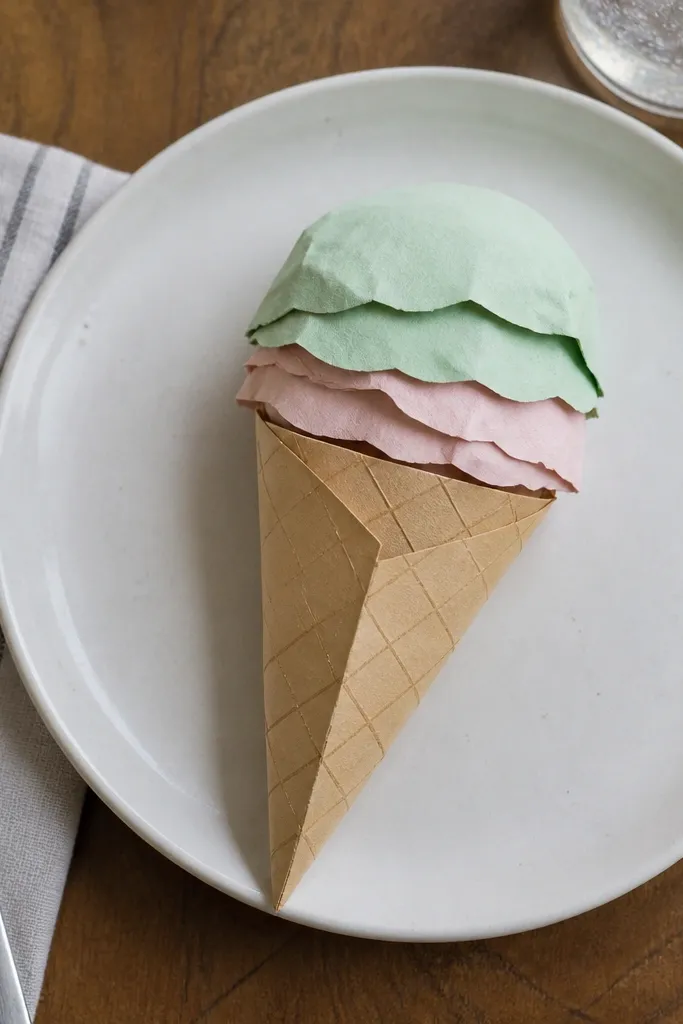 Folded ice cream cone with a textured-looking waffle pattern and scoops