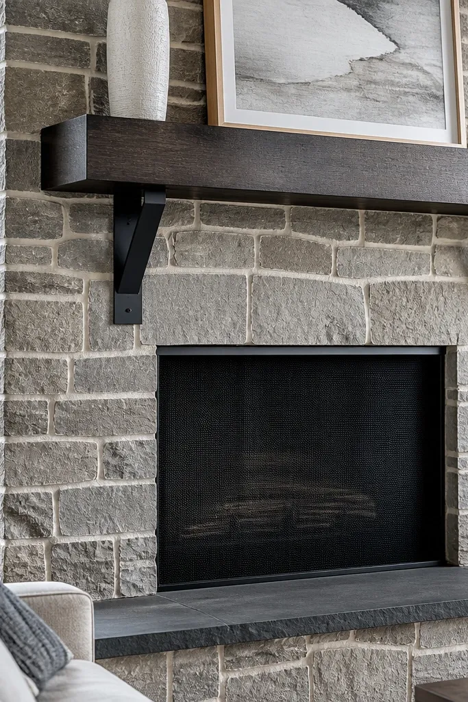 Stone fireplace with noticeable white mortar joints and charcoal mantel accents.