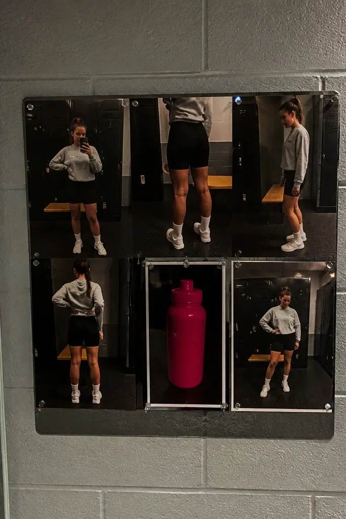 Gray sweatshirt, black bike shorts, sporty sneakers, and cap arranged in a streetwear layout