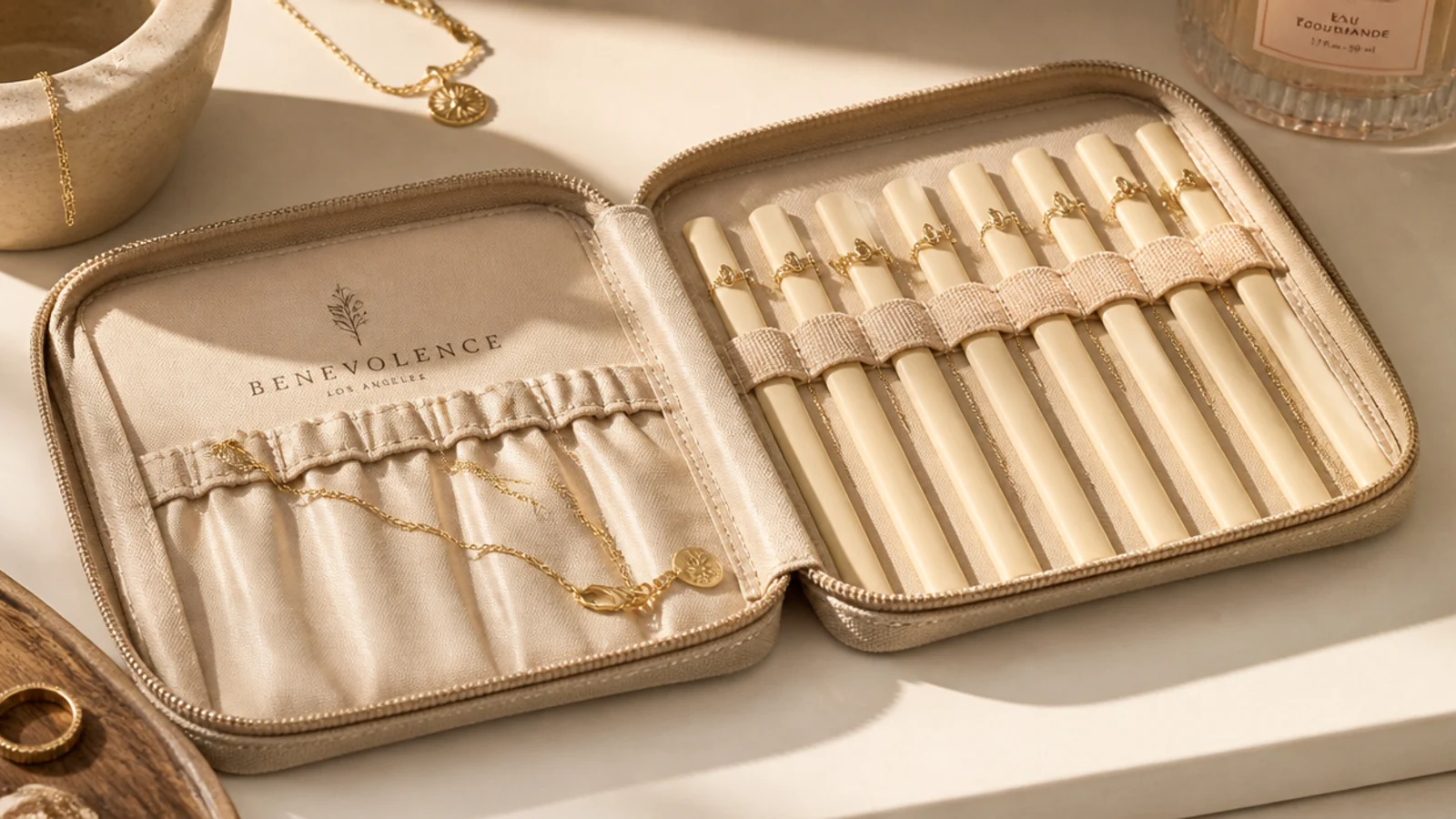 Delicate necklaces threaded through drinking straws with clasps fastened, lying straight and untangled in a pouch.