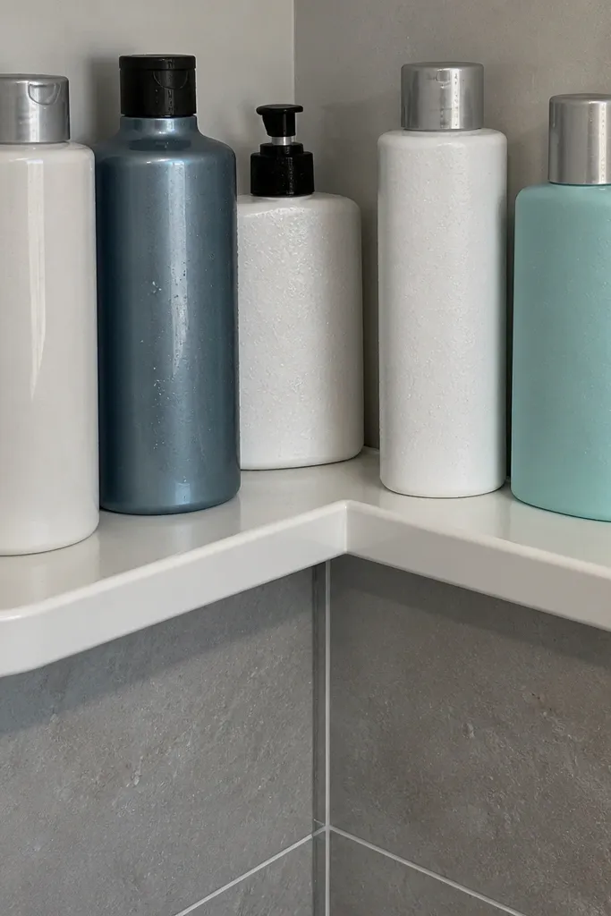 Two corner shelves wrap around with a light wood finish and rounded shelf edges.