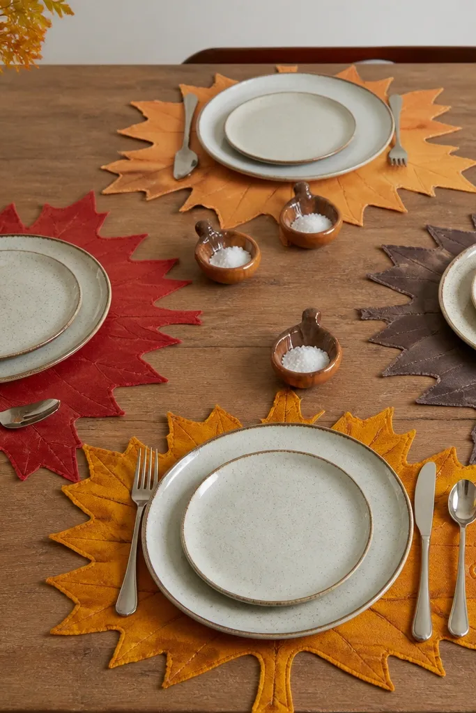 Maple leaf placemats with acorn-shaped dishes in the center