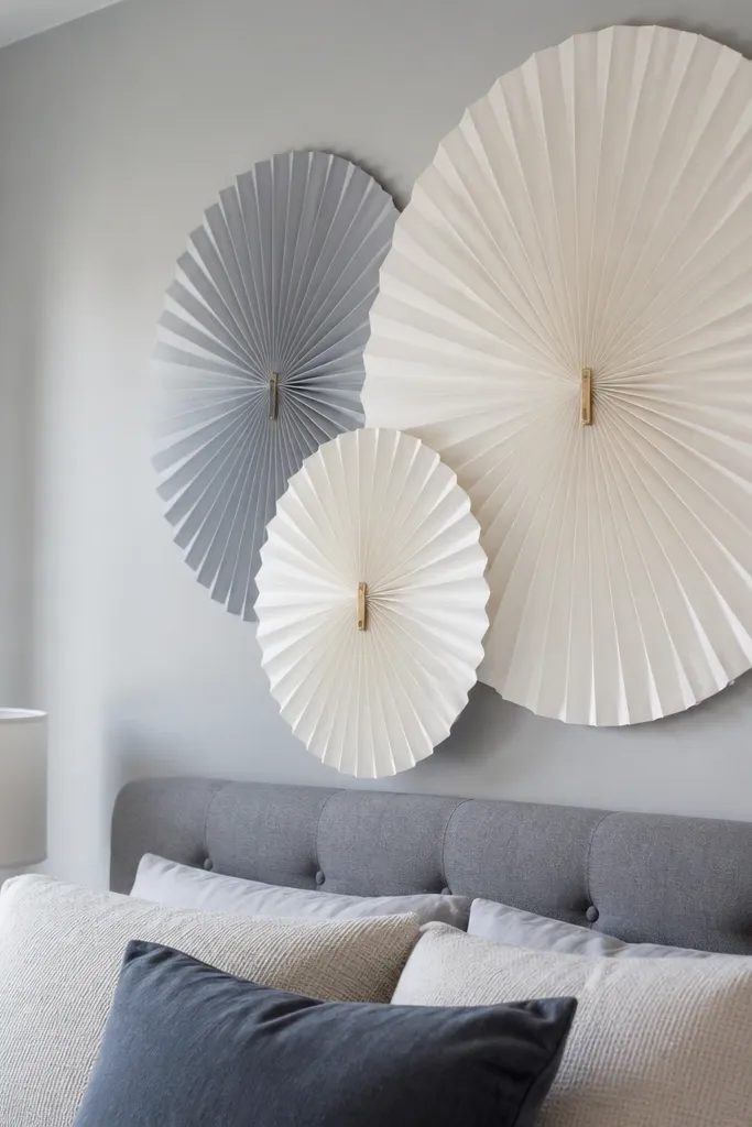 Grey headboard with layered paper fans in muted white and grey